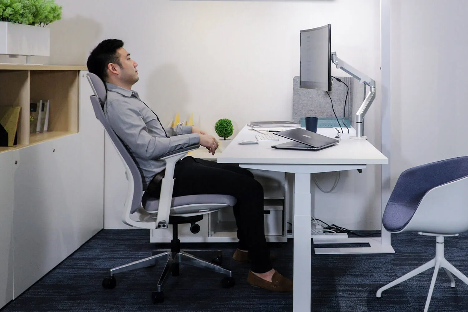 Notebook beside keyboard under focused desk lamp